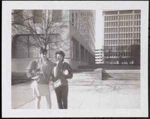 Two women with purses posing, possibly Technology Square