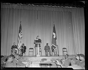 Speaker at lectern on stage