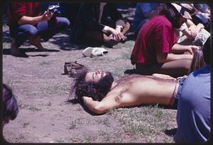 Man lying in park, possibly Cambridge Common