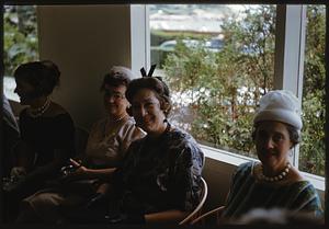 Women sitting in front of window and smiling, Swampscott, Massachusetts