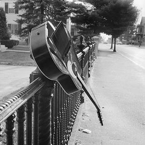 Broken guitar on fence, Union Street, New Bedford