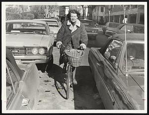 Coffee at home with daughter Joan, 21, who is recuperating from a knee operation. A chuckle on her way to lunch. When the weather's good enough she rides her bike as her contribution to solving Cambridge's transportation problems.