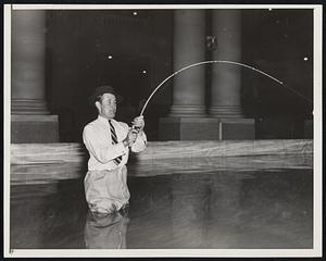 Preparing for Sportsmen's Show. Paul Runyan, noted golfer, trying his skill in casting at Grand Central Palace today, as preparations were completed for the opening of the annual show tomorrow. At the show the two-time winner of the P.G.A. Championship will give daily exhibitions of shot-making.