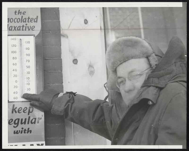 42 Below--Dick Meyer of Presque Isle, Me., points to thermometer indicating how the temperature dipped to 42 below zero early yesterday and didn't get above zero during the day. Northern Maine residents got the comparatively comforting forecast that this morning wouldn't be colder than -25.