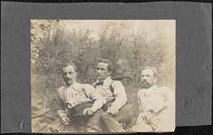 Three young men in shirtsleeves smoking pipes