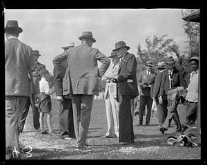 A group of unidentified people speaking together outdoors