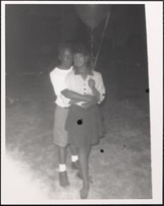 Couple with balloons embracing