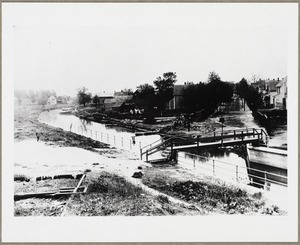 View of footbridge on Alewife Brook Henderson Street in the background on right