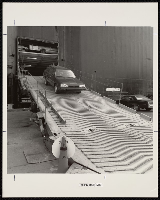 Automobile being driven off of a car-carrier in the Port of Boston