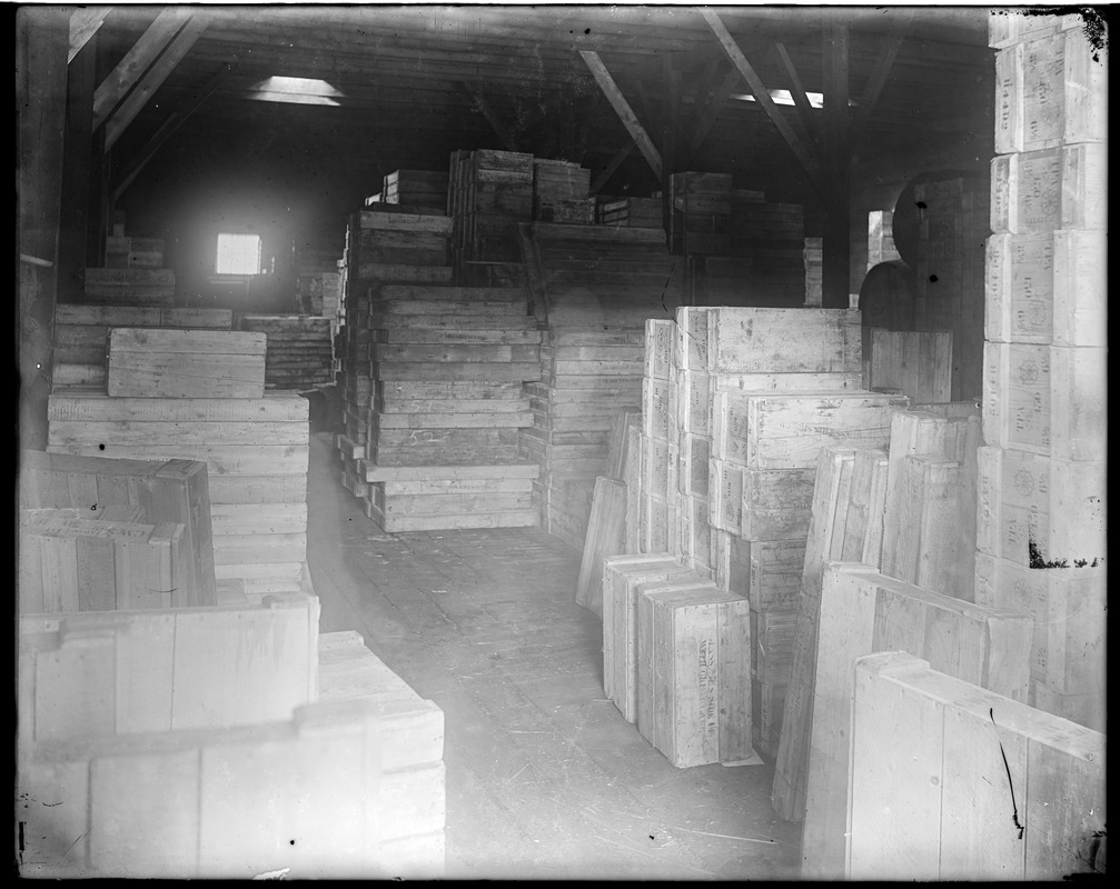 Interior of warehouse w/ stacked crates (glassworks?)