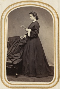 Portrait of a woman standing while reading a letter
