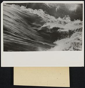 Deluge. Rushing flood water photographed just after levees broke on the Big Lake-Little River neear Blyhteville, Ark., sending a cascade of water over surrounding territory. Thousands of persons are being made homeless by the rising flood waters.