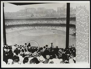 Death at the Polo Grounds--Circle indicates area in Section 42 of the left field grandstand in the Polo Grounds here where a spectator, identified as Bernard Lawrence Doyle, 50, of Union City, N.J., was shot to death mysteriously as more than 40,000 persons gathered for a double-header between the New York Giants and the Brooklyn Dodgers. Doyle slumped forward and spurts of blood came from both ears and a hole above the left temple. An ambulance surgeon pronounced him dead. In background are apartment houses on Coogan's Bluff. Police theorized the bullet came from a distance of about a half mile.