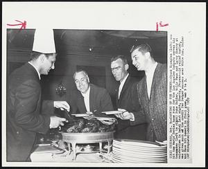 Carving Up The Turkey--Chuck Essegian (left) who hit two World Series home runs for the Los Angeles Dodgers serves his teammates (left to right) Duke Snider, Wally Moon and Larry Sherry at celebration in hotel last night. Sherry, 24-year-old relief hurler, was given much of the credit for Dodger success over White Sox. Snider and Moon hit homers in final game, won 9 to 3.