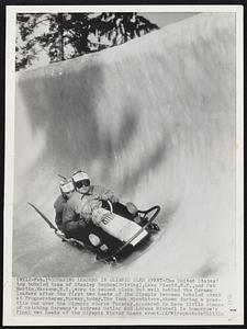 Chasing Leaders in Olympic Sled Event-The United States' top bobsled team of Stanley Benham (driving), Lake Placid, N.Y., and Pat Martin, Massena, N.Y., were in second place but well behind the German leaders after the first two heats of the Olympic two-man bobsled event at Frognerseteren, Norway, today. The Yank speedsters, shown during a practise run over the Olympic course Tuesday, appeared to have little chance of catching Germany's Andreas Ostler and Lorenz Nieberl in tomorrow's final two heats of the Olympic Winter Games event.