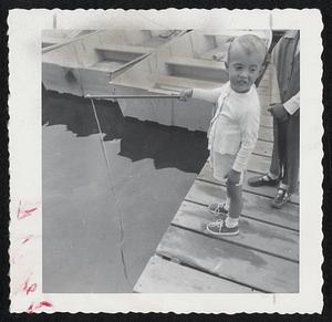 Nonchalant Angler-”A, that fish isn’t so big,” little John David Pasco seems to be saying here. The 21/2-year-old youngster is the son of Mr. and Mrs. John Pasco of South Boston. John is shown fishing at Halifax, Mass.