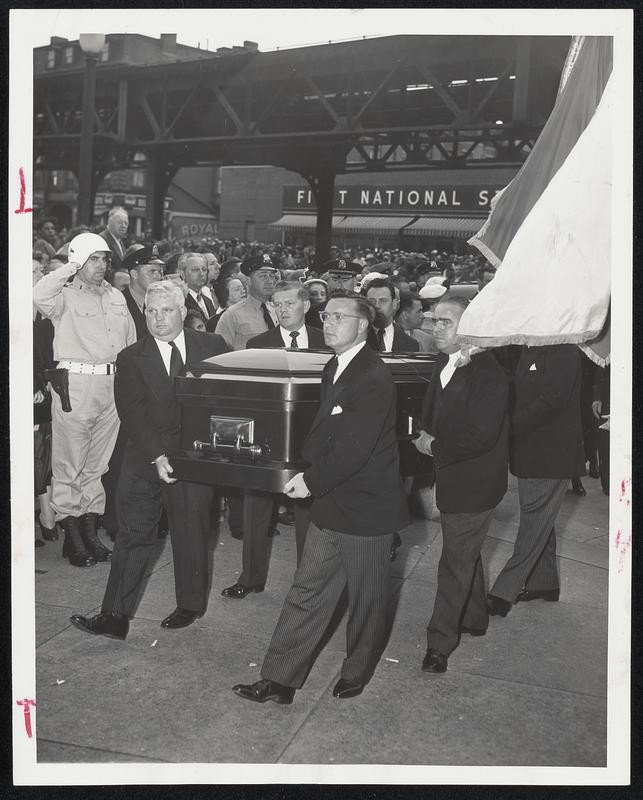 Casket Arrives – The body of Maurice J. Tobin is carried into Holy Cross Cathedral as a National Guardsman (left in white helmet) stands at attention.