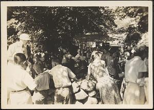 Children near dairy booth, street far