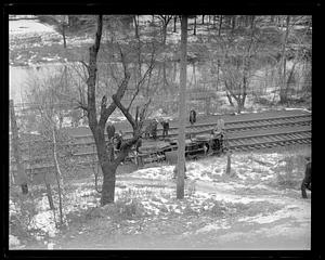 Wrecked Gulf truck overturned by the side of railroad tracks