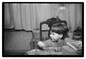 Toddler sitting a table