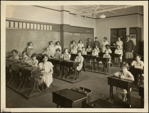 School children sitting at desks in classroom on Long Island in Boston Harbor