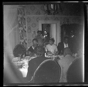 A group of people are seated at a dining table