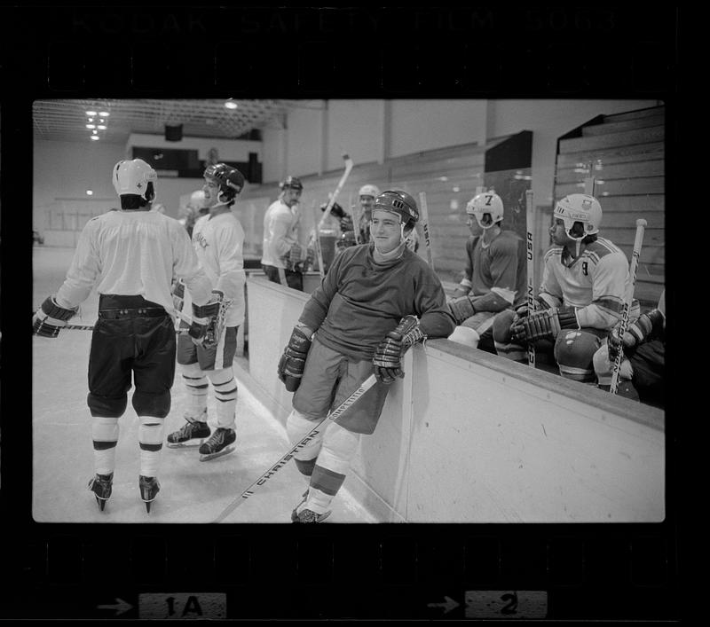 Youth hockey players gather around bench, Woburn Digital Commonwealth