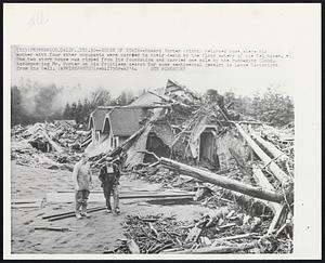 House of Death--Howard Porter (right) returned home where his mother with four other occupants were carried to their death by the flood waters of the Eel River. The two story house was ripped from its foundation and carried one mile by the rampaging flood. Accompanying Mr. Porter on his fruitless search for some sentimental jewelry is Lance Cartwright from Rio Bell.