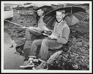 Good Weather for Fish-A little rain doesn’t bother Bob McEachern and Joe Murphy of Dorchester. They keep partly dry with umbrellas while fishing off Victory Rd., Dorchester.