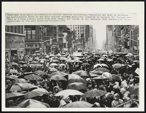 Umbrellas Protect Antiwar Protesters--Umbrellas are much in evidence as participants march in the rain through midtown Manhattan Saturday to protest the Vietnam war. This is a view looking south from 40th Street and Avenue of the Americas (6th Avenue).