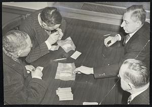 Diamond buyers examining some of loot seized from smugglers by officers