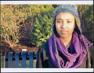 Young person in knit hat and purple scarf