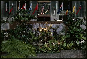 View of Prometheus statue through plants, Rockefeller Center, Manhattan, New York
