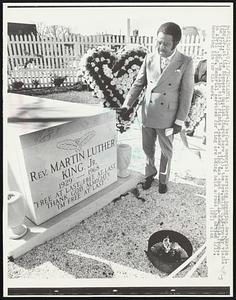 Shortly before memorial services honoring Rev. Martin L. King, Jr., at the Ebenezer Baptist Church here 1/15, the Rev. Ralph D. Abernathy visits the grave of the slain civil rights leader. King was shot down in Memphis, Tenn., in April 1968. Memorial services for King are being held across the nation 1/15, honoring him for his work.