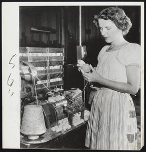 The First Windup-Rose Gancarz checks a baseball for loose ends after first winding of rough wool yarn in the manufacturing of baseball at the A. G. Spalding plant in Chicopee. The machine winds two balls at a time.