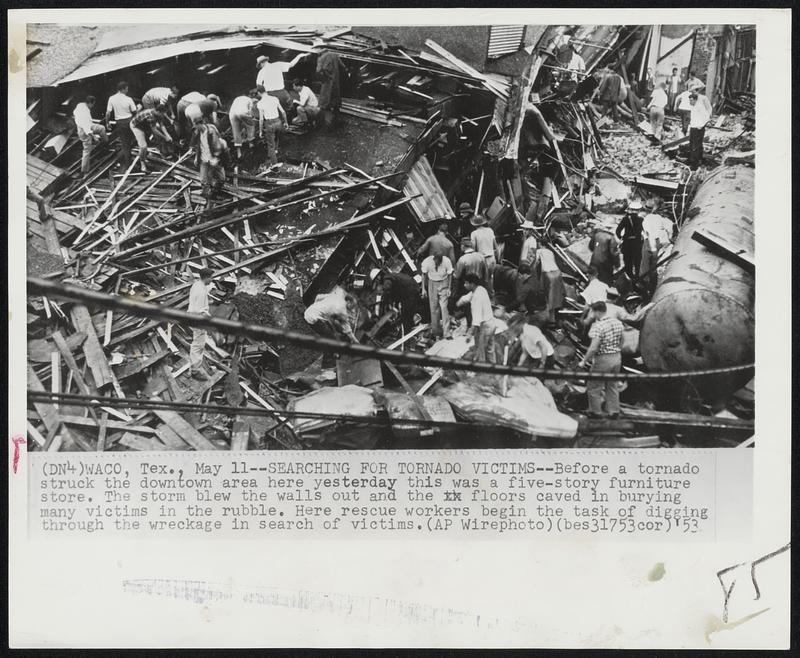 Searching for Tornado Victims--Before a tornado struck the downtown area here yesterday this was a five-story furniture store. The storm blew the walls out and the floors caved in burying many victims in the rubble. Here rescue workers begin the task of digging through the wreckage in search of victims.