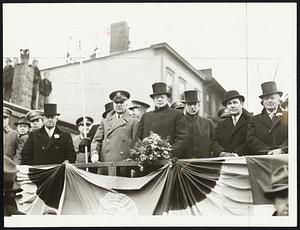 Left to right: Dist. Atty. William J. Foley, Adjt. Gen. Charles H. Cole, Mayor Mansfield, Rep. John W. McCormack, and State Auditor Thomas H. Buckley reviewing annual Evacuation Day parade at South Boston yesterday.