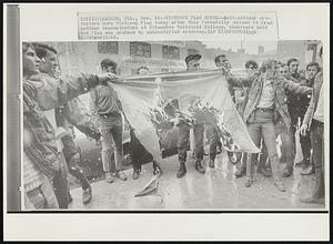 Vietcong Flag Burns--Anti-antiwar protesters burn Vietcong flag today after they forcefully seized it from antiwar demonstrators at Milwaukee Technical College. Observers said the flag was grabbed by unidentified veterans.