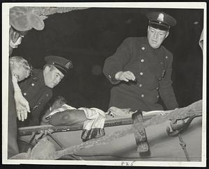 Tragedy in Boston Garden Ring-The unconscious Ed Sanders, who died yesterday afternoon, is carried from ring on a stretcher by Boston police after being knocked out in 11th round of bout with Willie James.