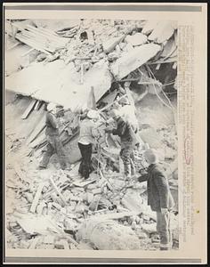 Rescue workers search ruins of collapsed building here 10/27 for victims or survivors of earthquake that struck this central Yugoslavian city. Twenty bodies have been recovered from the rubble of buildings destroyed by shocks 10/26 and 10/27.