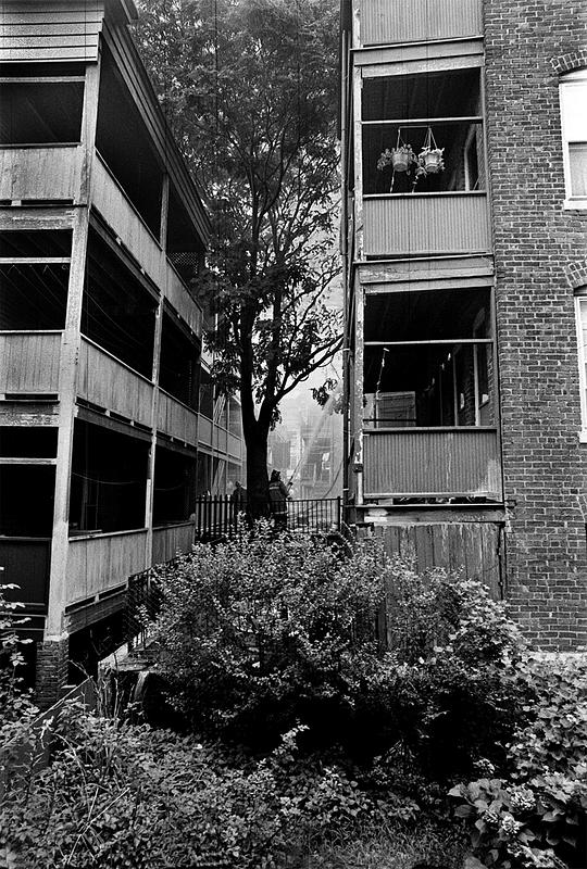 Firefighters attacking the fire in the rear of the building