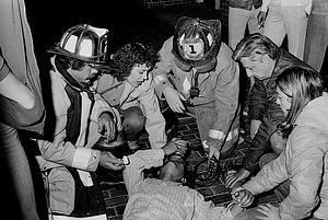 Left to right, firefighter John O'Driscoll, Capt. Paul Riley and firefighter George Mastrangelo render aid to a patient during a medical call