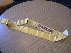 Gold sash with the word marshal on it