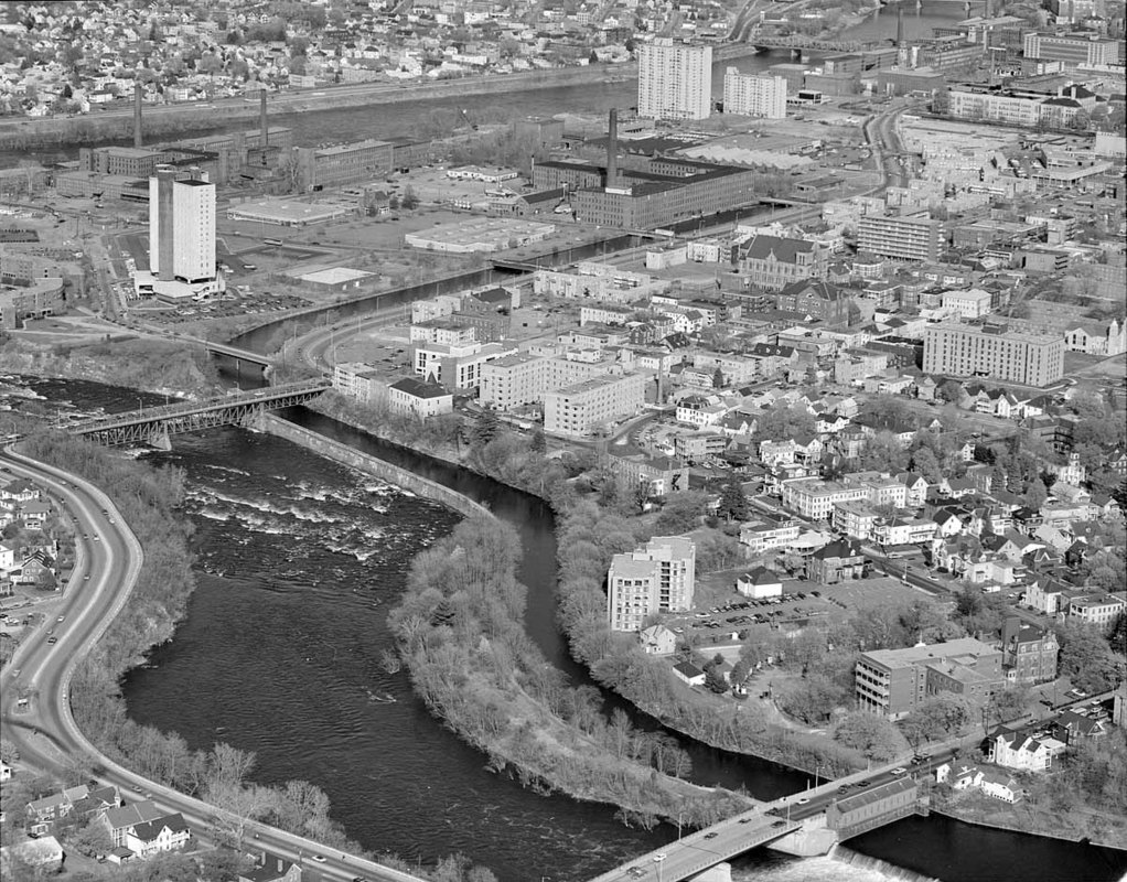 Looking from Merrimack River near School Street Bridge, over St. Joseph's Hospital across Lawrence/Suffolk (Wannalancit) Mills