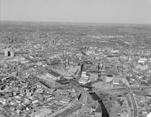 Looking northeast to Downtown and big view of Lowell from Pawtucket Canal where it branches off to Hamilton and Merrimack Canals