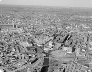 Looking northeast along Pawtucket Canal at split by Pellon over Downtown towards big view of Lowell beyond Merrimack River