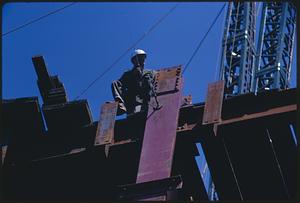 Construction worker on steel frame of building, Boston