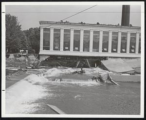 Powerless From Floods-The big power plant of the American Optical Company in Southbridge was badly torn by the water. All power was cut off in town of 17,500 which was isolated for days.