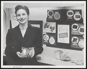 Commerce Exhibit-Sheraton. Mrs. Marjorie Desorneau - Washington. Secretary in Commerce Dept. - holds package of potato - One exposed to radiation thus preserving it & the other no treatment which has allowed it to rot