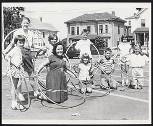Hoop Whirling Winners in Gilchrist’s Whoop-The-Hoop Contest held at the Waltham store last Saturday are (front row left to right) Maureen Cullen of Weston, Janet Norris of Newton, Ida Cassella of Waltham, Gordon Burns of Waltham, Marian Parkinson, Robert McNamara of West Newton, Pamela Reese of West Newton. More than 400 youngsters competed for bicycle and cash prizes, and every possible trick with the new hoops was demonstrated with amazing ability.